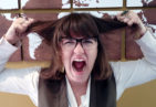 A teacher feeling stressed and pulling her hair.
