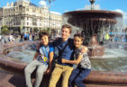 Greenheart Traveler with host siblings in front of a fountain in Russia.